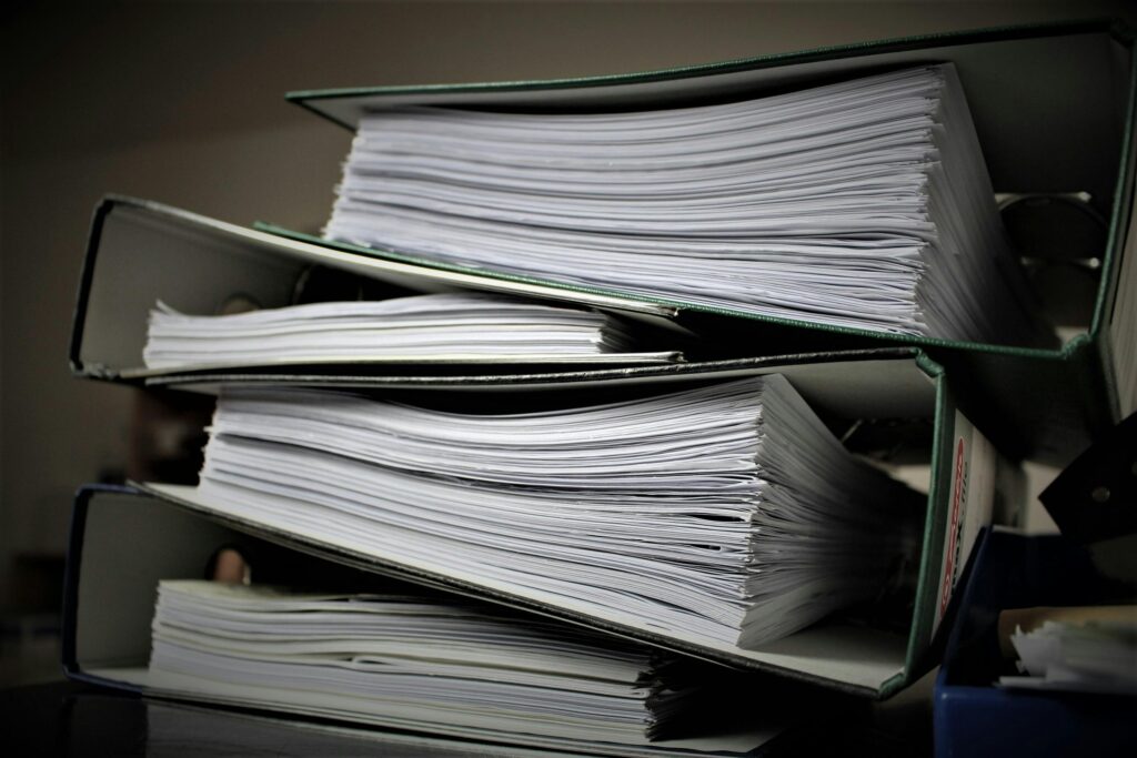 pexels-photo-357514-357514 Close-up of stacked binders filled with documents for office or educational use.
